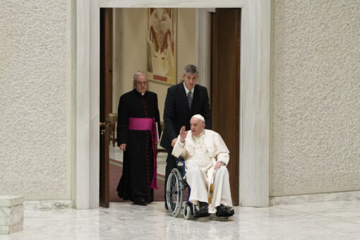Pope Francis seen publicly in wheelchair for first time, citing knee pain