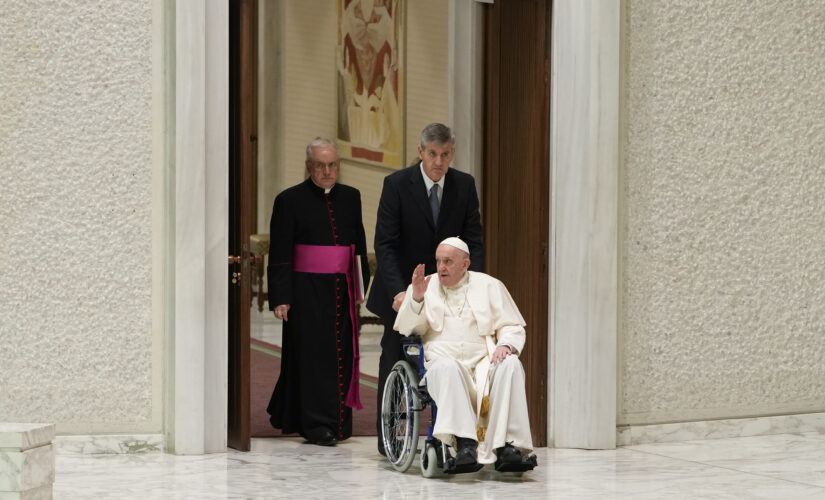 Pope Francis seen publicly in wheelchair for first time, citing knee pain