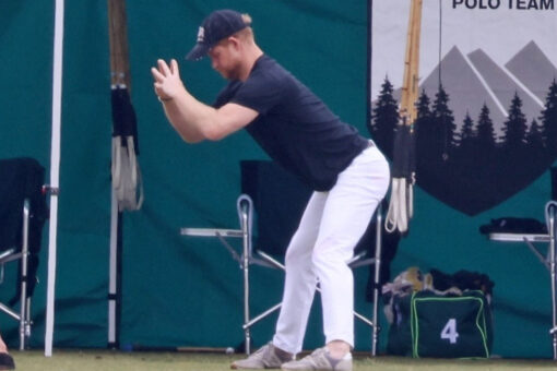 Prince Harry enjoys a deep stretch before a polo match in Santa Barbara