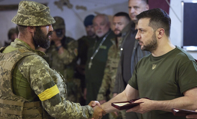 Ukraine’s Zelenskyy visits front lines in south as Russian forces pound strategically important city in east