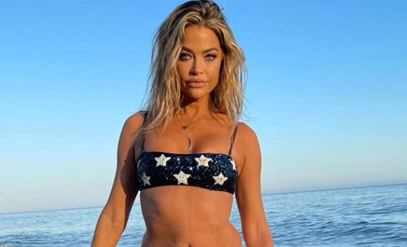 Denise Richards rocks patriotic bikini to celebrate July 4th on the beach after joining OnlyFans