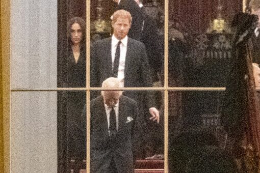 King Charles III awaits Queen Elizabeth II’s casket with Prince Harry and Meghan Markle at Buckingham Palace