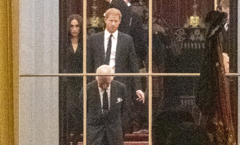 King Charles III awaits Queen Elizabeth II’s casket with Prince Harry and Meghan Markle at Buckingham Palace