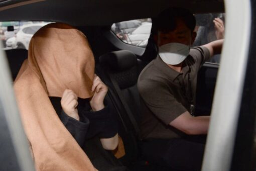 South Korean woman accused of killing 2 children and hiding bodies in suitcases extradited to New Zealand