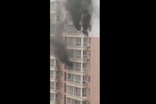 Video captures China residents clinging to ledge as fire rages in high-rise apartment building