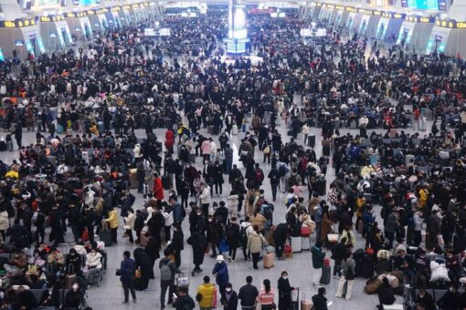 China downplays COVID risks with Lunar New Year travel in full swing